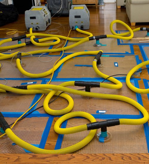 Water mitigation pumps and dryers to suck the water out of a flooded hardwood floor